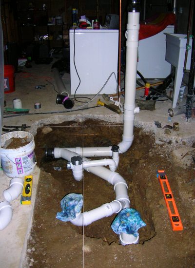 PVC pipe construction for soon to be bathroom drain. When complete wet concrete will be poured over to complete the job.